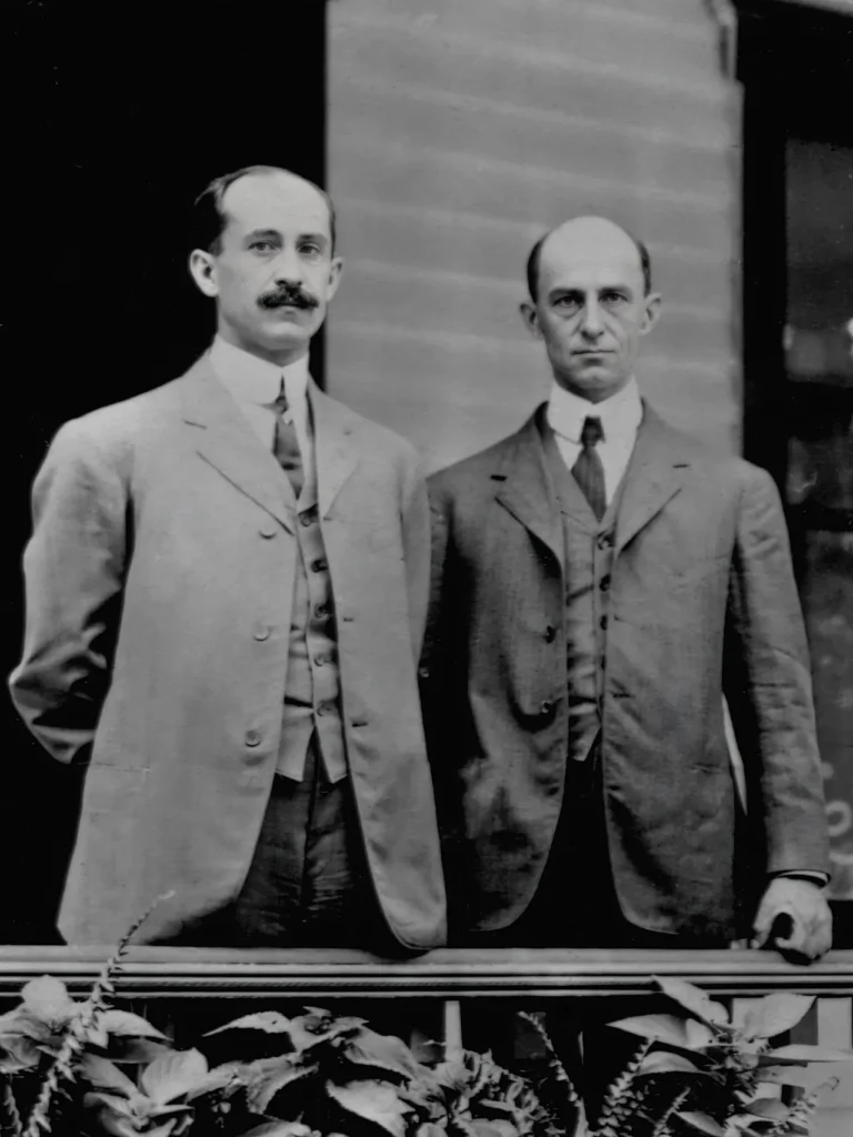Formal 1909 portrait of two early aviation pioneers, accompanying a Productive Failure essay about experimentation and learning.